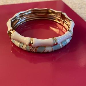 Two bracelets: one light blue and one white